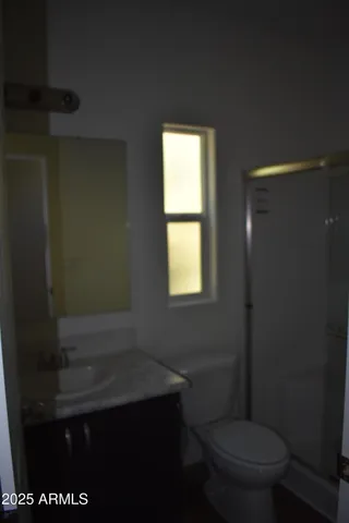 a bathroom with a toilet a sink and a window