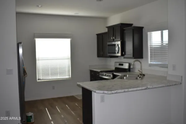 a kitchen with a sink stove and microwave