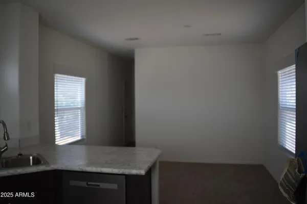 a kitchen with windows and cabinet