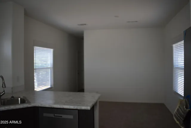 a kitchen with windows and cabinet