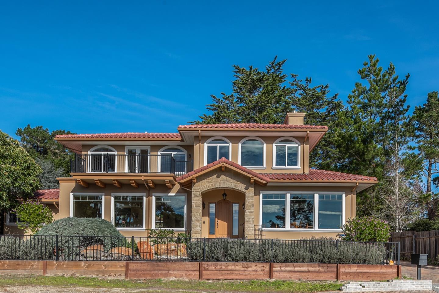 a front view of a house with a garden