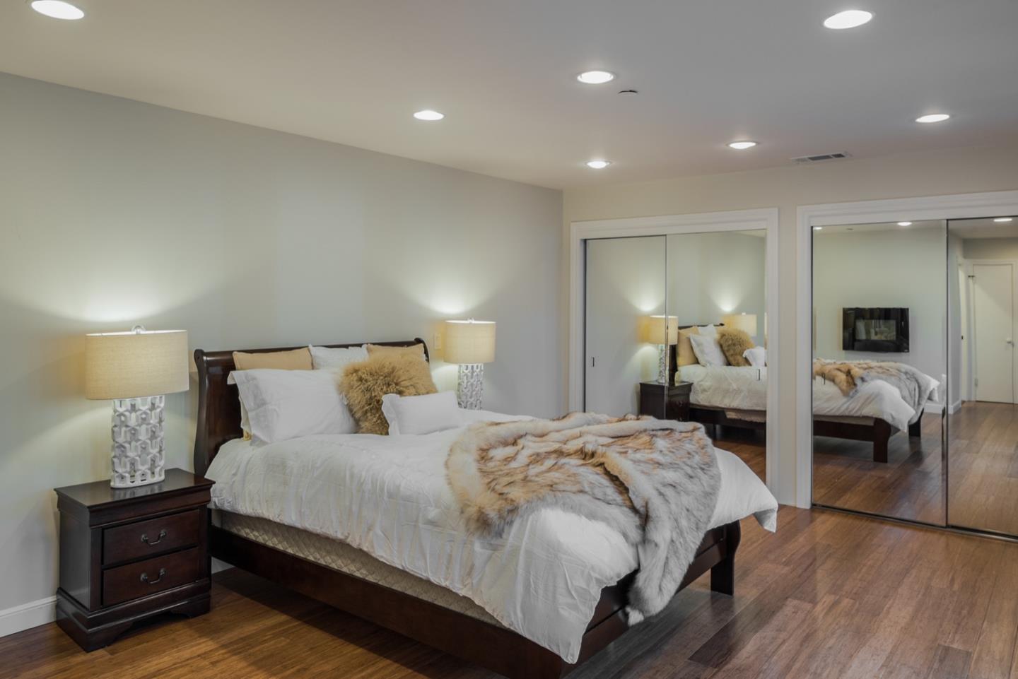 4157 Sunridge Road Pebble Beach, CA 93953 - Photo 15 of 25 a bedroom with a bed and lamp