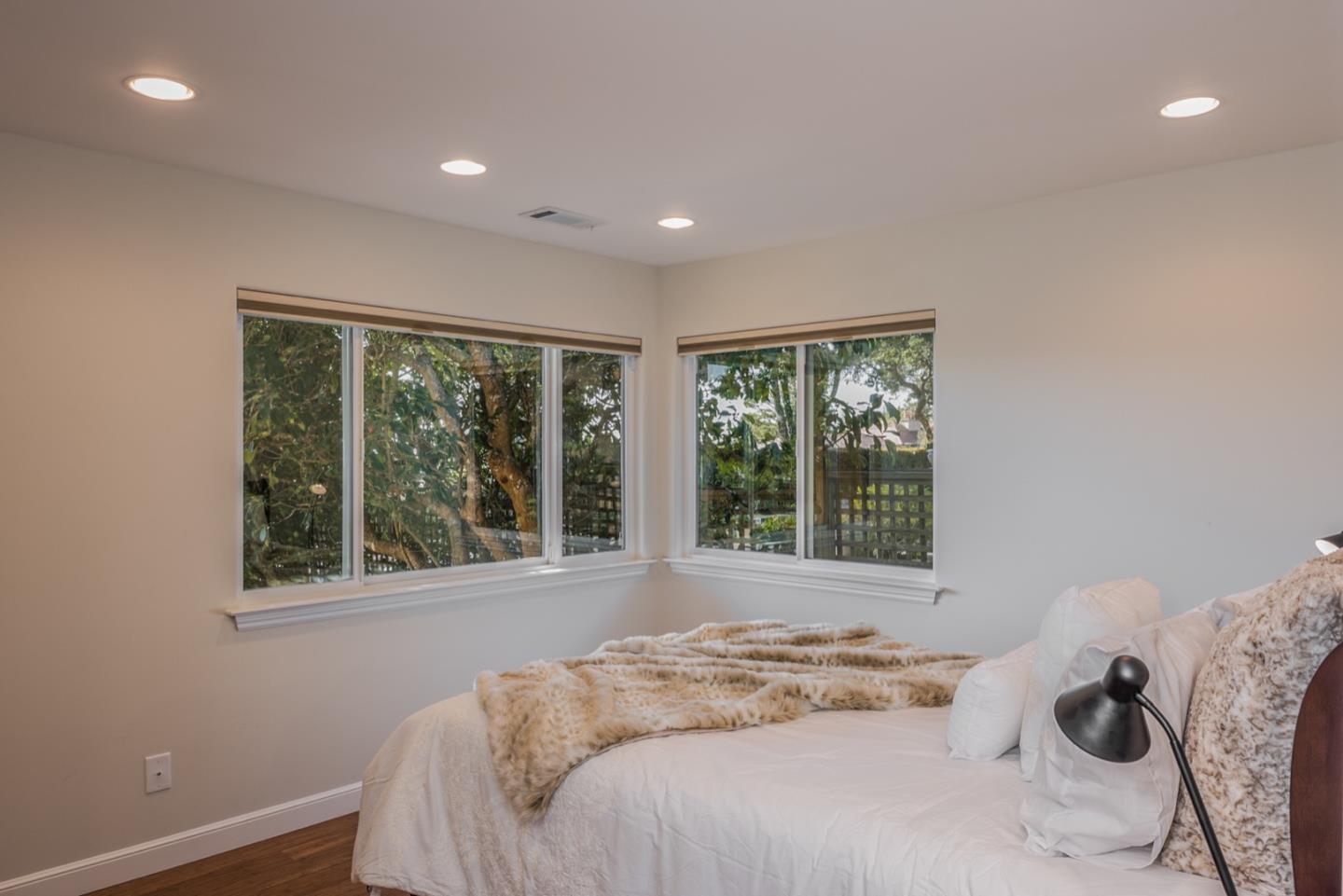 4157 Sunridge Road Pebble Beach, CA 93953 - Photo 19 of 25 a bed sitting in a spacious bedroom next to a window