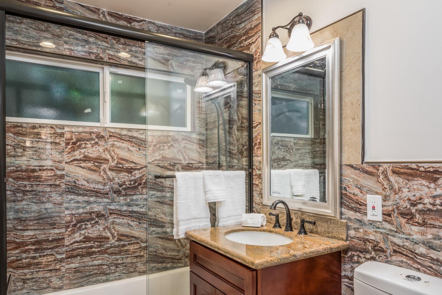 4157 Sunridge Road Pebble Beach, CA 93953 - Photo 21 of 25 a bathroom with a sink and a mirror