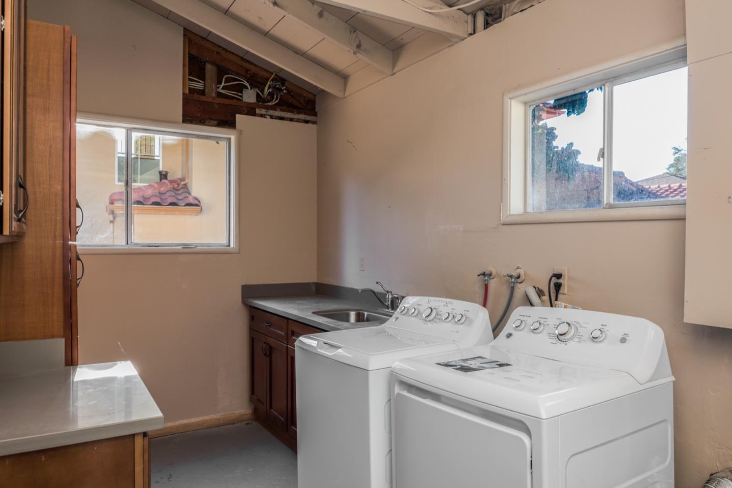 4157 Sunridge Road Pebble Beach, CA 93953 - Photo 22 of 25 a utility room with dryer and washer