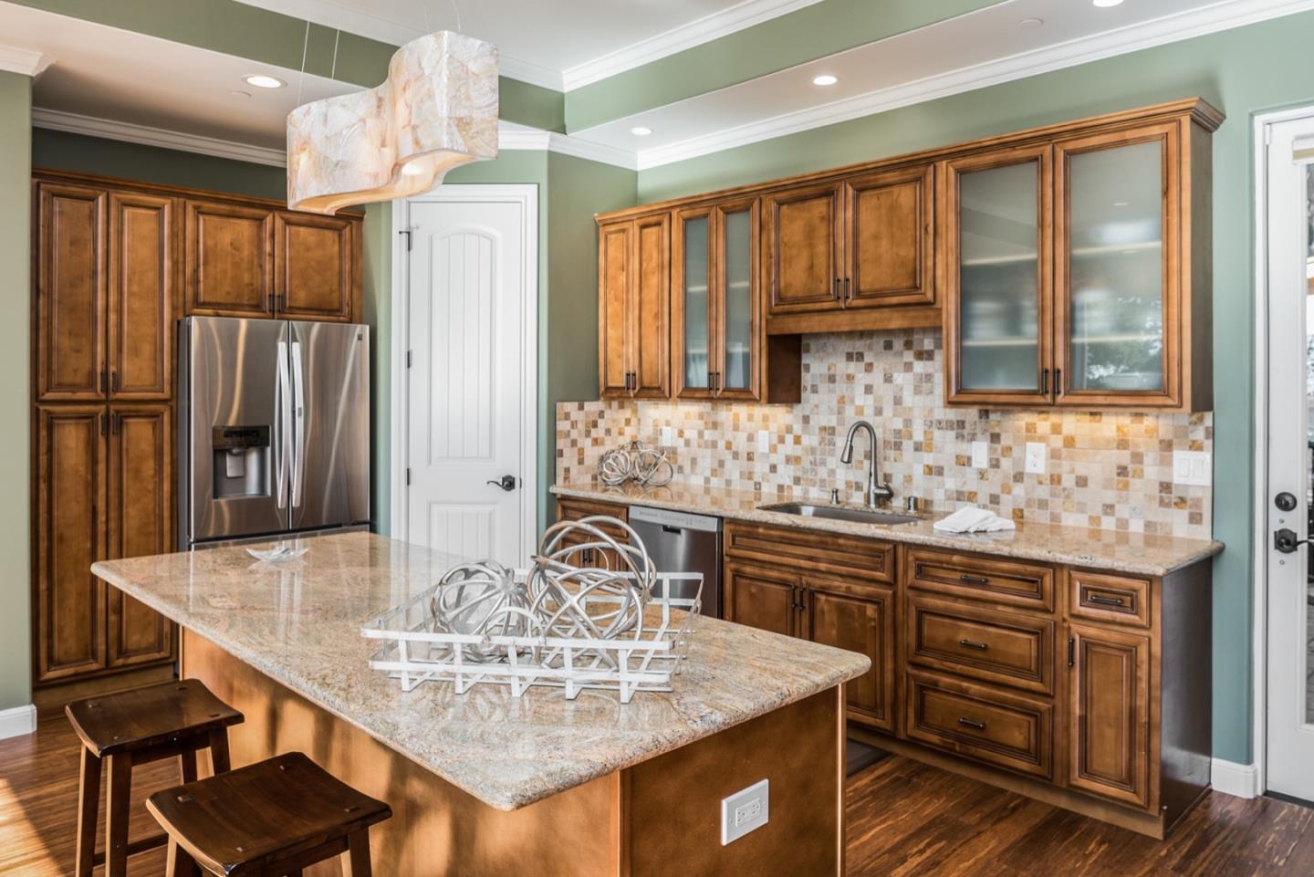 4157 Sunridge Road Pebble Beach, CA 93953 - Photo 4 of 25 a kitchen with granite countertop a sink cabinets and stainless steel appliances