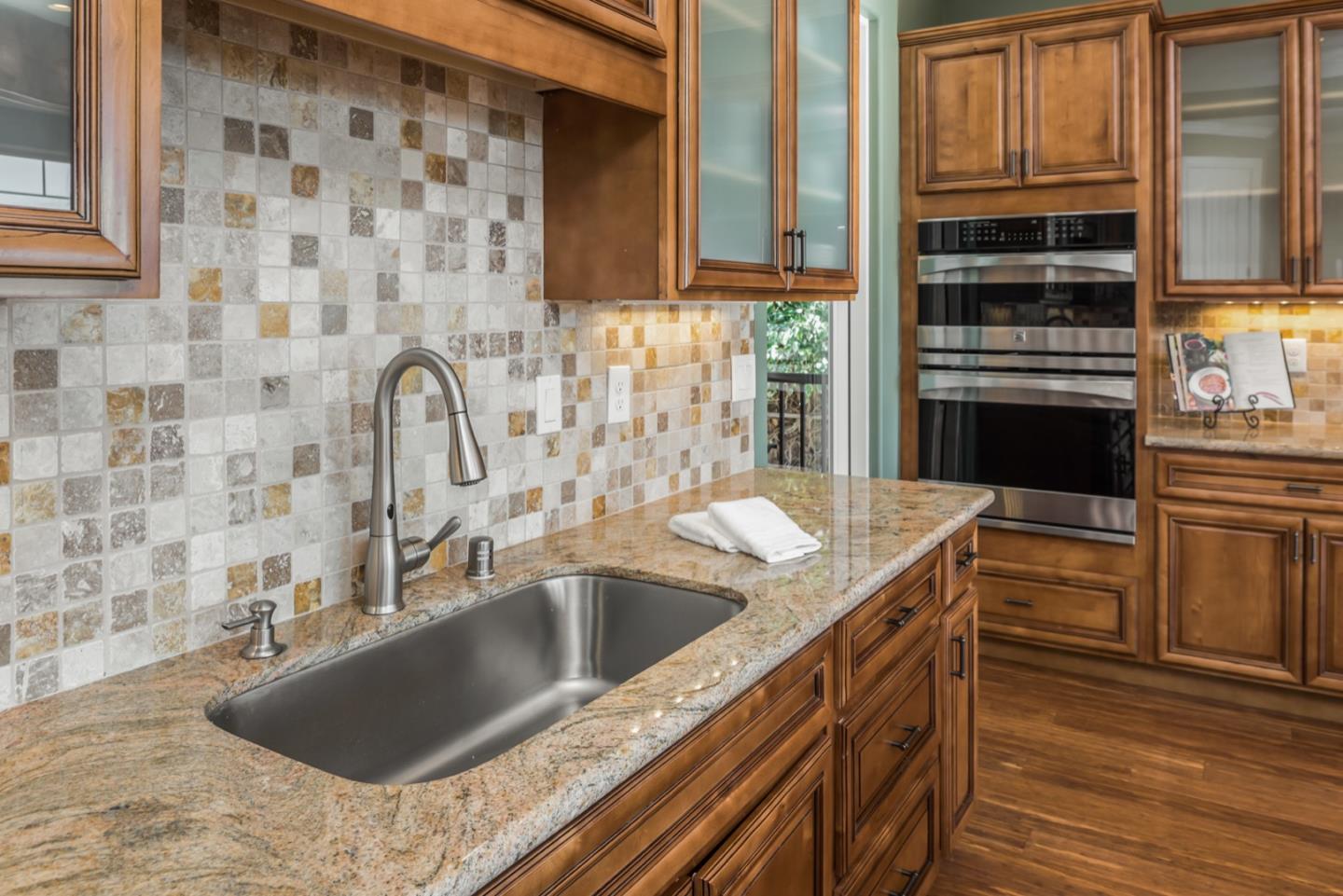 4157 Sunridge Road Pebble Beach, CA 93953 - Photo 5 of 25 a kitchen with a sink stove and cabinets