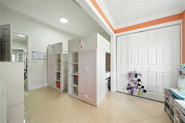a bedroom with two beds and a flat screen tv
