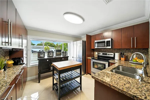 a kitchen with a stove a sink and a microwave