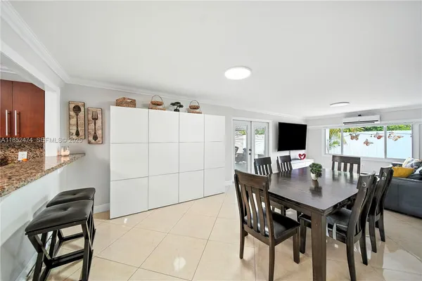 a view of a dining room with furniture and a kitchen