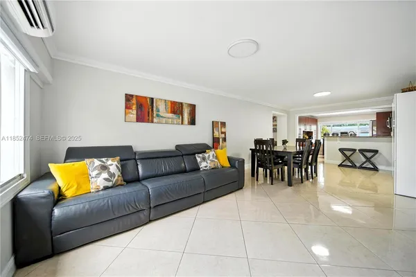 a living room with furniture and kitchen view