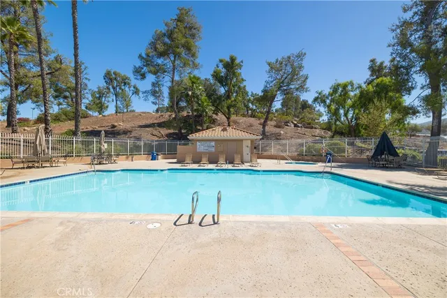 a view of a house with pool and a yard