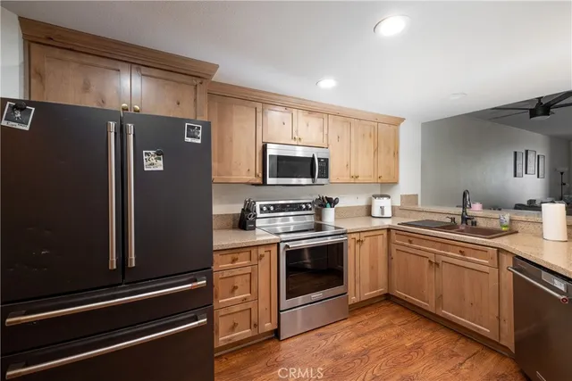 a kitchen with a sink stainless steel appliances and cabinets
