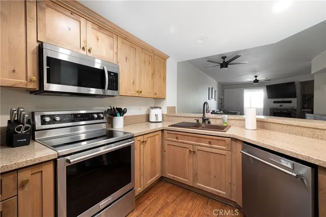 a kitchen with stainless steel appliances a sink cabinets and a microwave oven