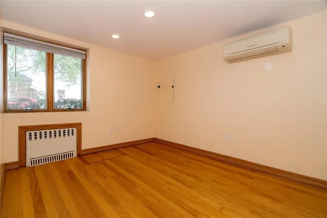 a view of a room with wooden floor and window