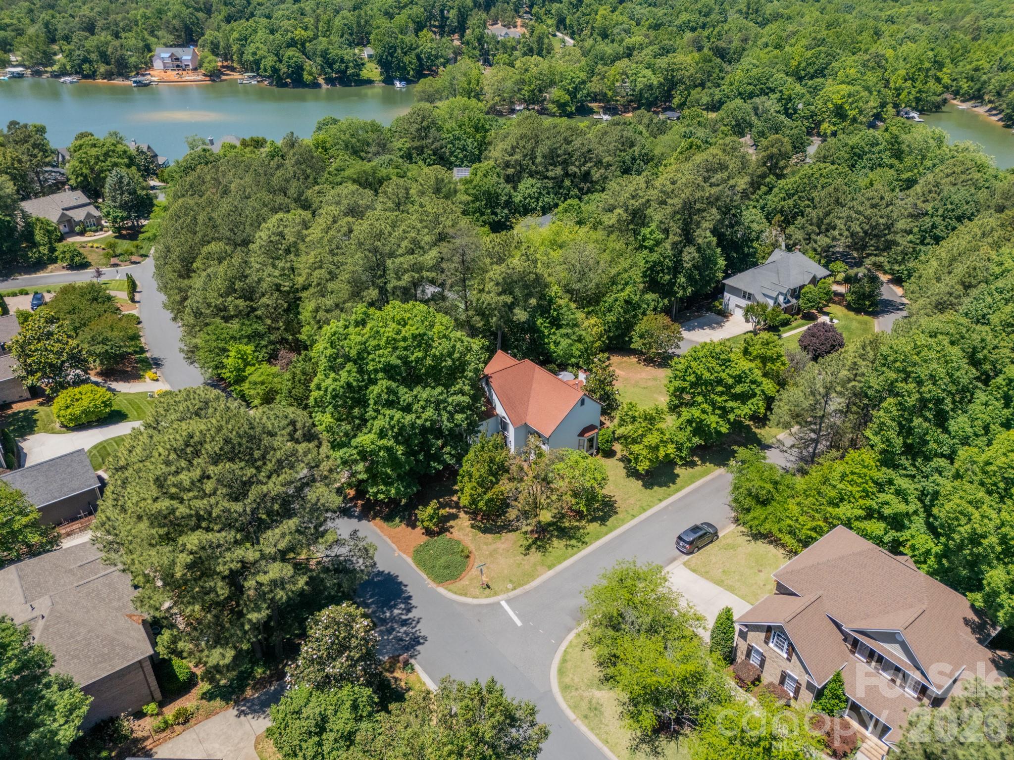 11043 Seven Coves Drive Tega Cay, SC 29708 - Photo 41 of 45 an aerial view of a house with a yard and lake view