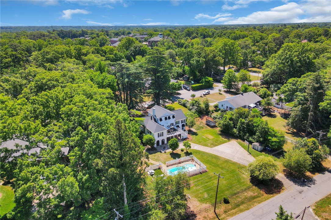 1107 Springdale Road Anderson, SC 29621 - Photo 47 of 49 An aerial perspective reveals a charming home with an inviting pool, nestled within a lush, verdant landscape.