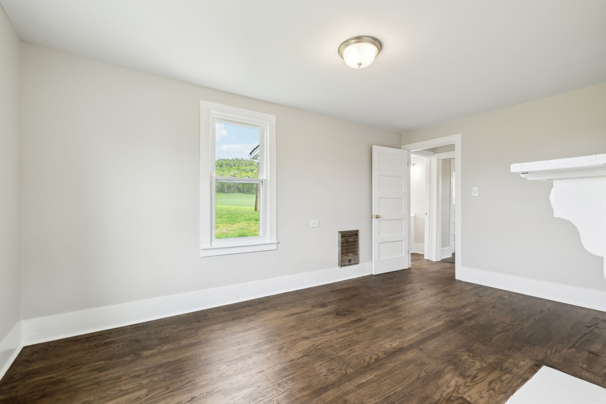 57 Young Branch Road Dixon Springs, TN 37057 - Photo 15 of 24 an empty room with wooden floor and windows