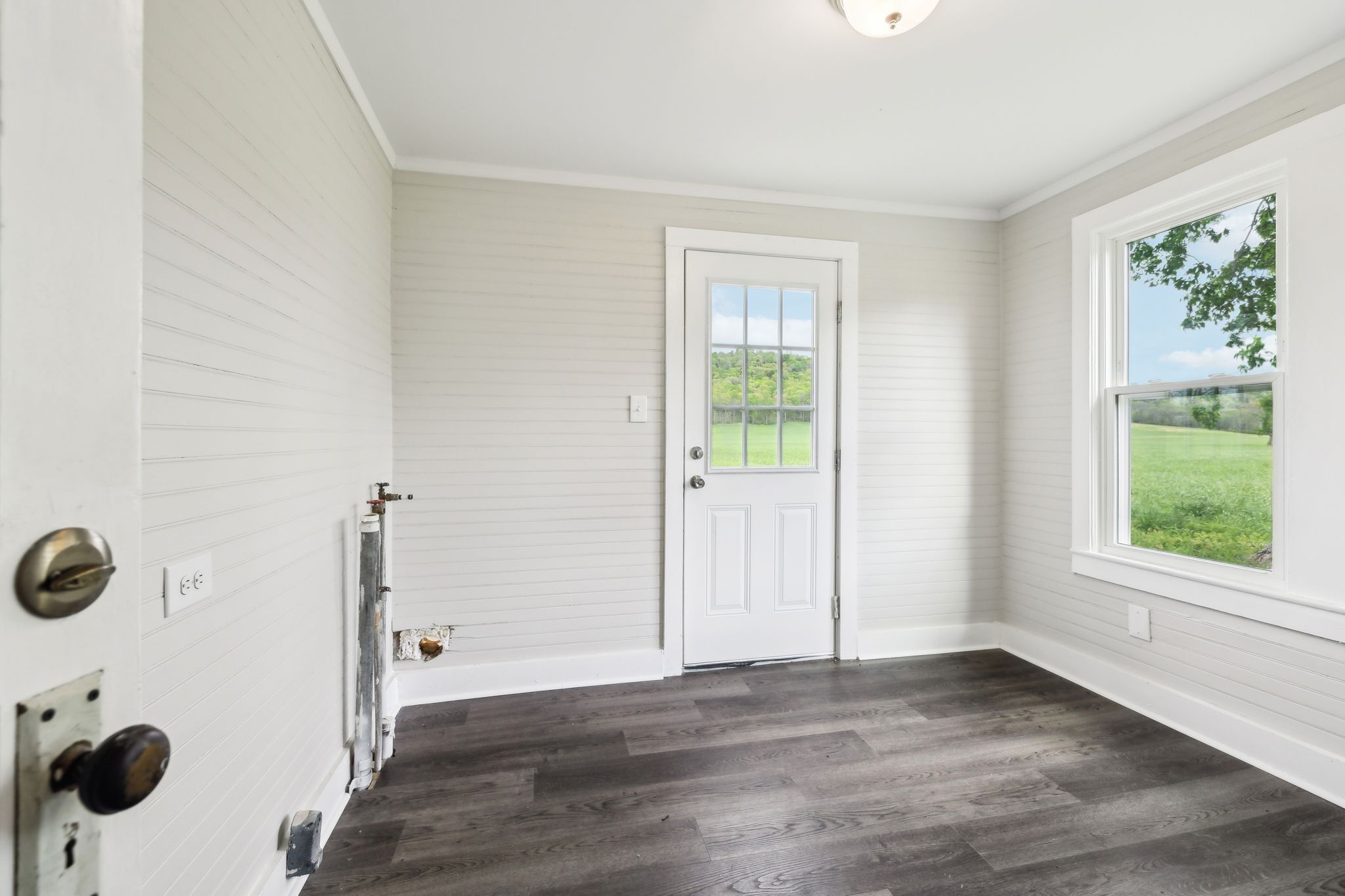 57 Young Branch Road Dixon Springs, TN 37057 - Photo 22 of 24 a view of an empty room with wooden floor and a window