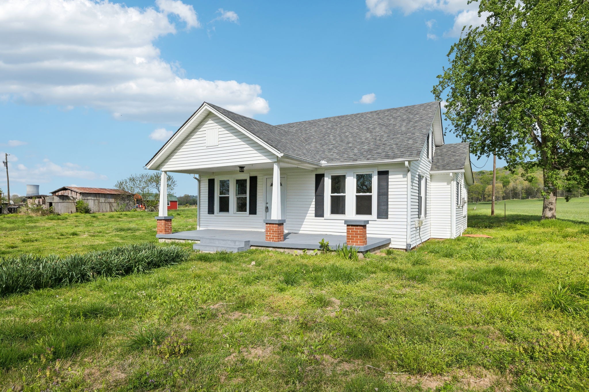 57 Young Branch Road Dixon Springs, TN 37057 - Photo 3 of 24 a front view of a house with a garden and porch