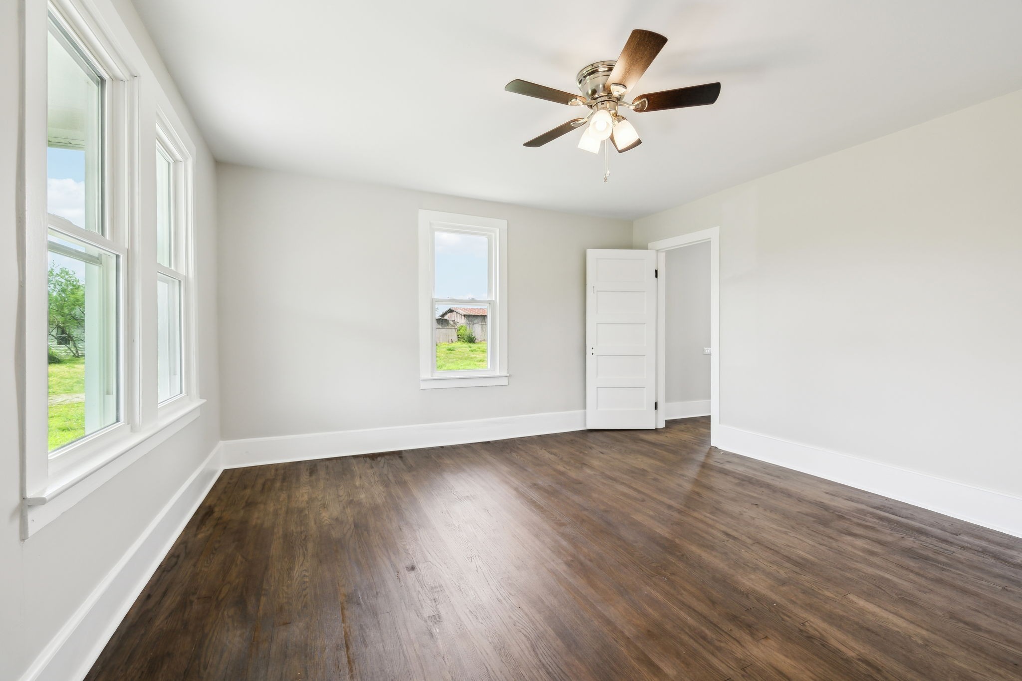 57 Young Branch Road Dixon Springs, TN 37057 - Photo 4 of 24 an empty room with wooden floor fan and windows