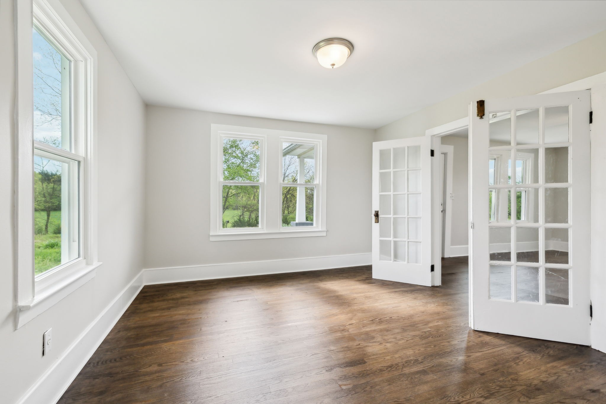 57 Young Branch Road Dixon Springs, TN 37057 - Photo 7 of 24 an empty room with wooden floor and windows