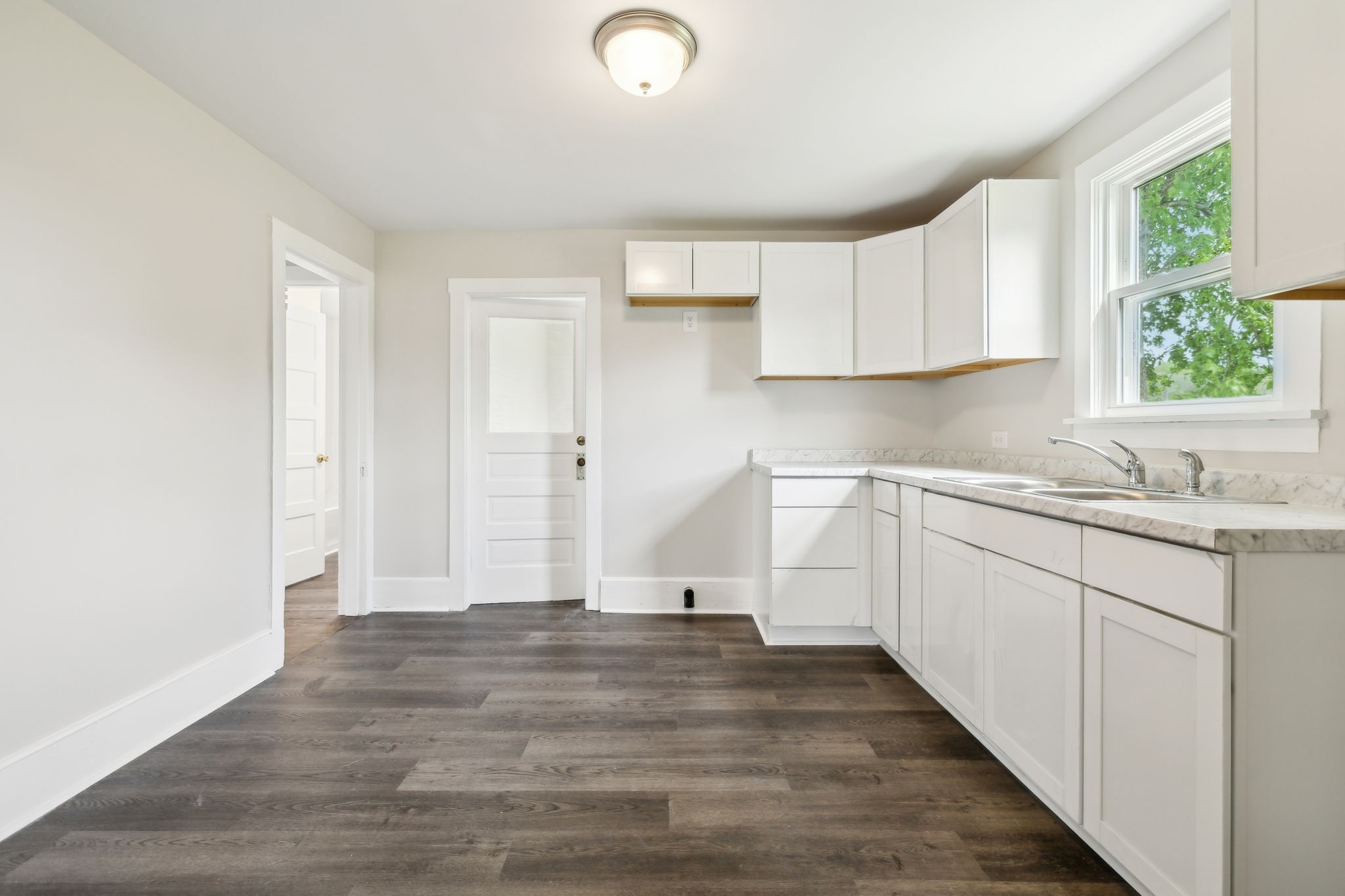 57 Young Branch Road Dixon Springs, TN 37057 - Photo 9 of 24 a view of a kitchen with sink dishwasher and wooden floor