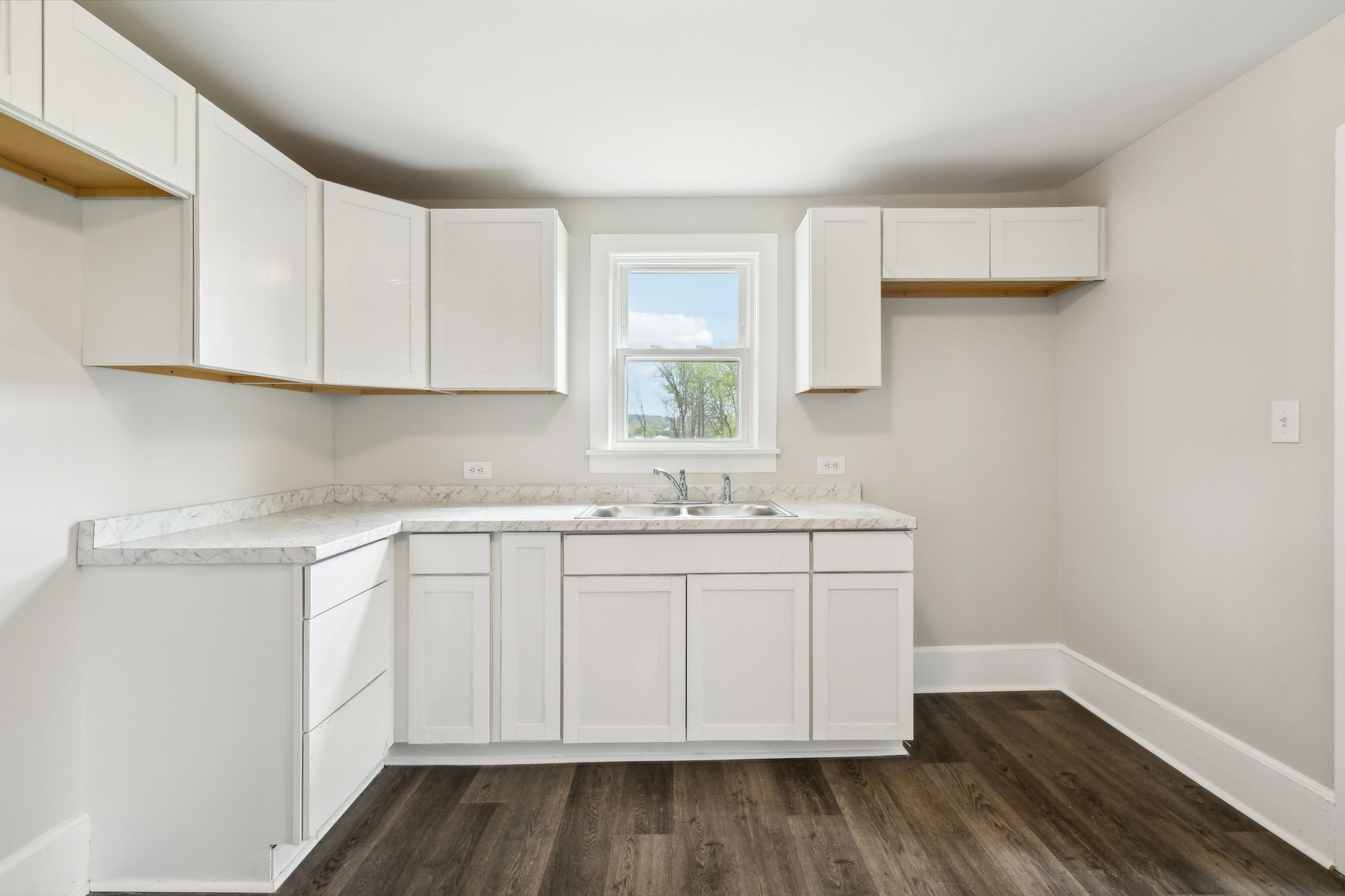 57 Young Branch Road Dixon Springs, TN 37057 - Photo 10 of 24 a kitchen with a sink cabinets and wooden floor
