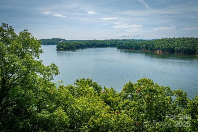 wooden view of a lake with houses in the back