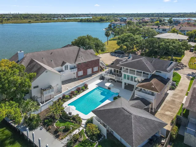an aerial view of a house with a lake view