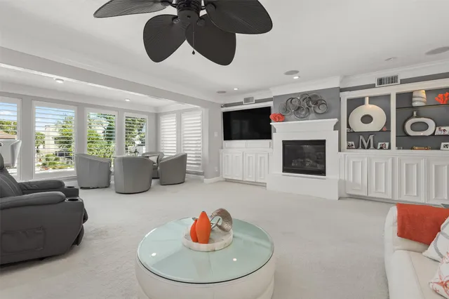 a kitchen with white cabinets and sink
