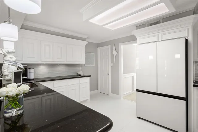 a spacious bathroom with a double vanity sink a mirror and a toilet