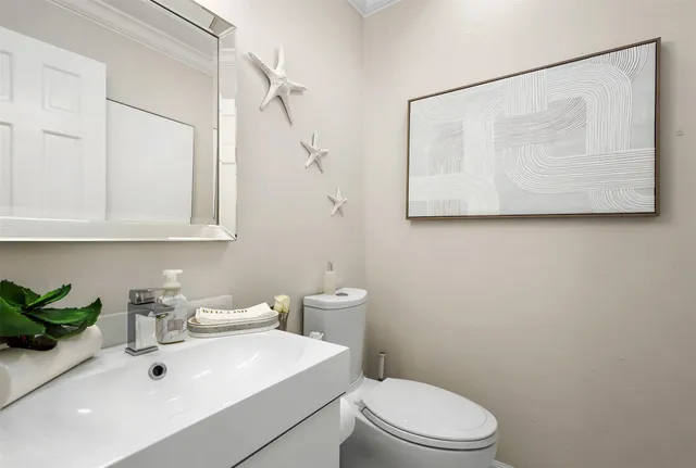 a spacious bedroom with a bed painting and a large window