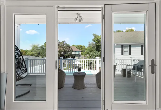 a bedroom with a bed and a chandelier fan