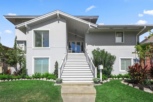an aerial view of ocean and residential houses with outdoor space