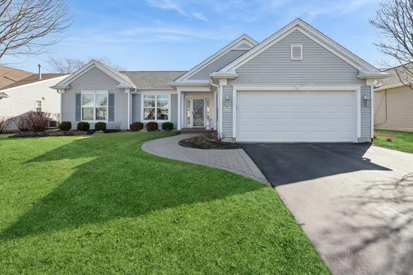 a view of a house with yard and garden