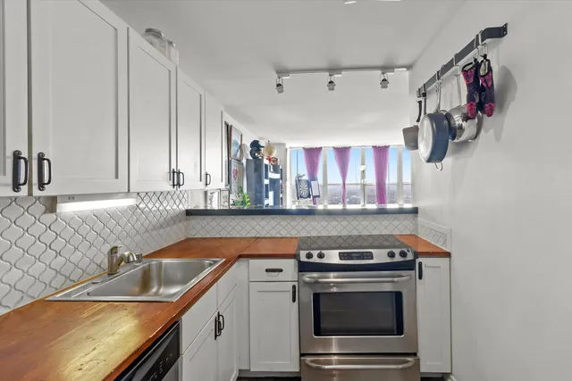 a kitchen with stainless steel appliances granite countertop a stove and a sink