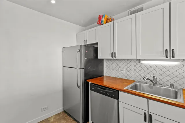 a kitchen with stainless steel appliances a refrigerator and a sink