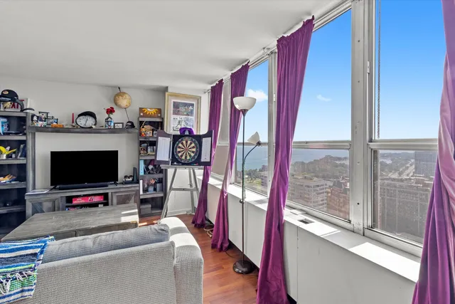 a view of a livingroom with furniture and a flat screen tv