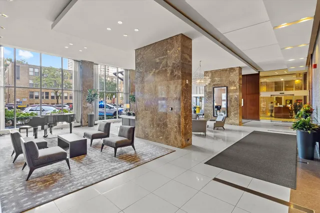 a living room with furniture and a floor to ceiling window