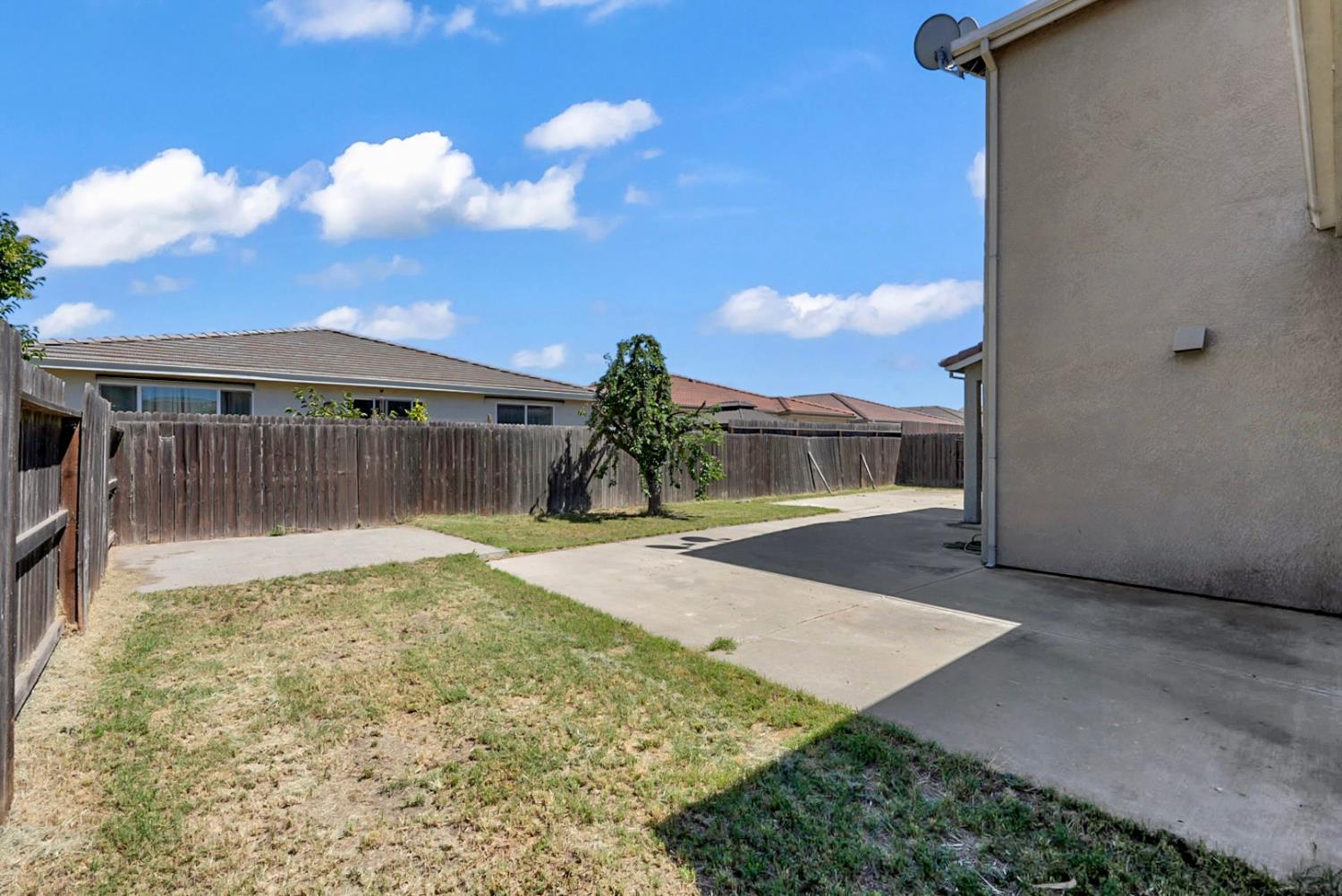 1412 Red Ribbons Lane Manteca, CA 95337 - Photo 16 of 32 a view of a house with a yard