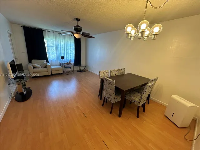 a view of a dining room with furniture and chandelier