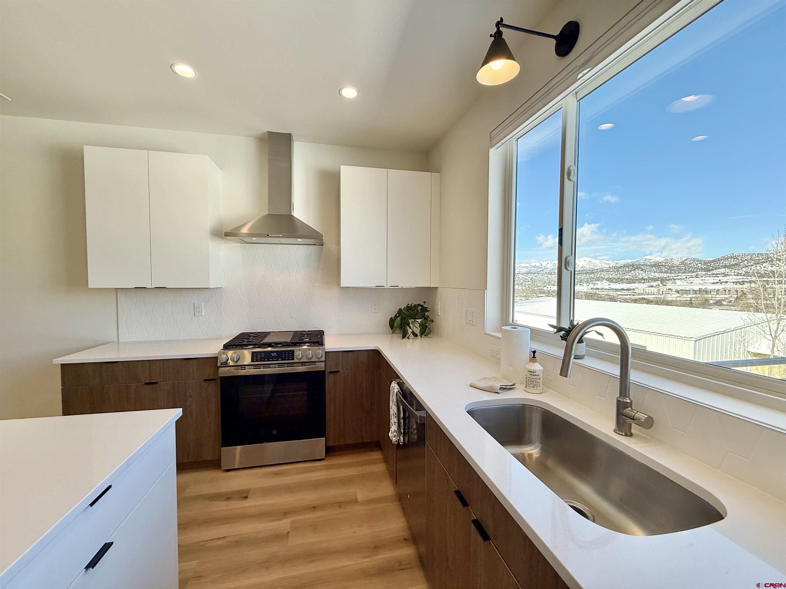 205 Treeline Street Durango, CO 81303 - Photo 7 of 39 a kitchen with stainless steel appliances granite countertop a sink a stove and a refrigerator