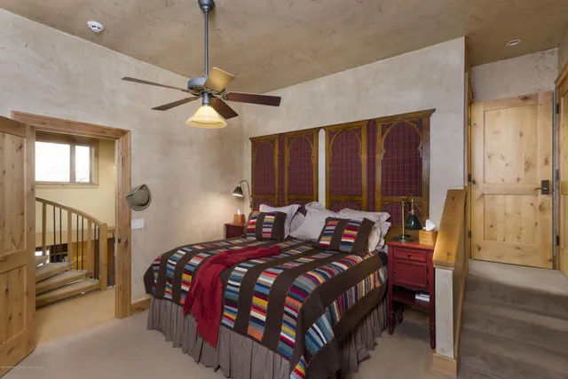 a bed room with a bed and a chandelier