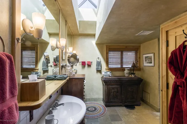 a bathroom with a sink a toilet and mirror