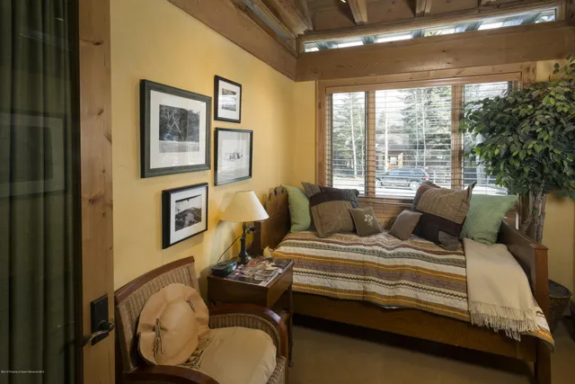 a bedroom with bed and wooden floor