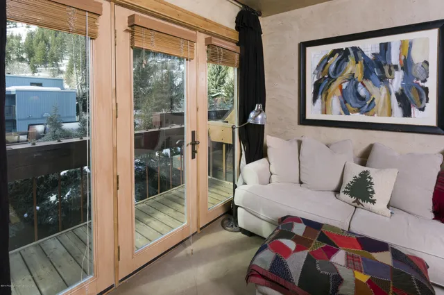 a bedroom with a bed and glass window
