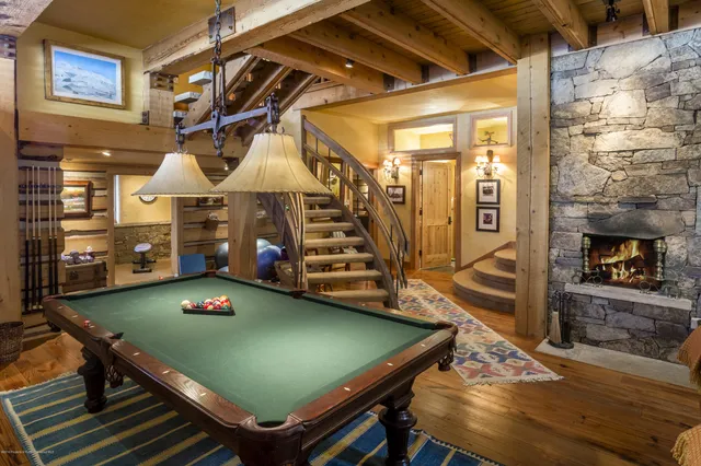 a room with pool table and windows