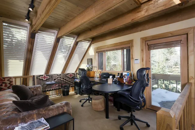 a view of a livingroom with furniture and a large window