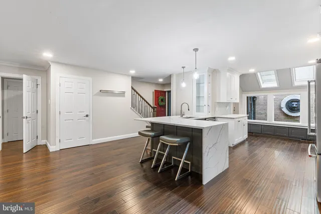 a large kitchen with a table and chairs